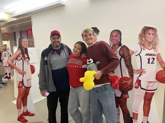 Photo of Students in front of women's basketball cutouts.