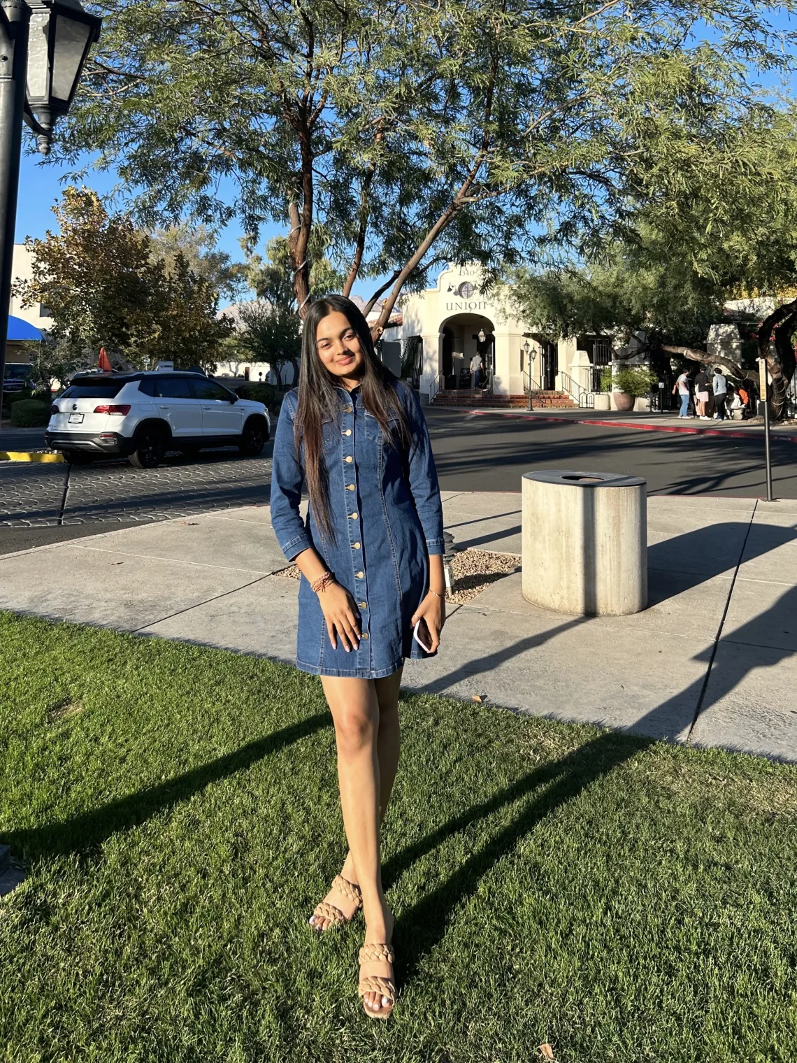 Kargi, an Arizona Senior standing in front of a restaurant in Tucson