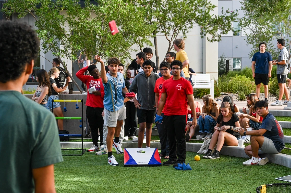 students playing corn hole