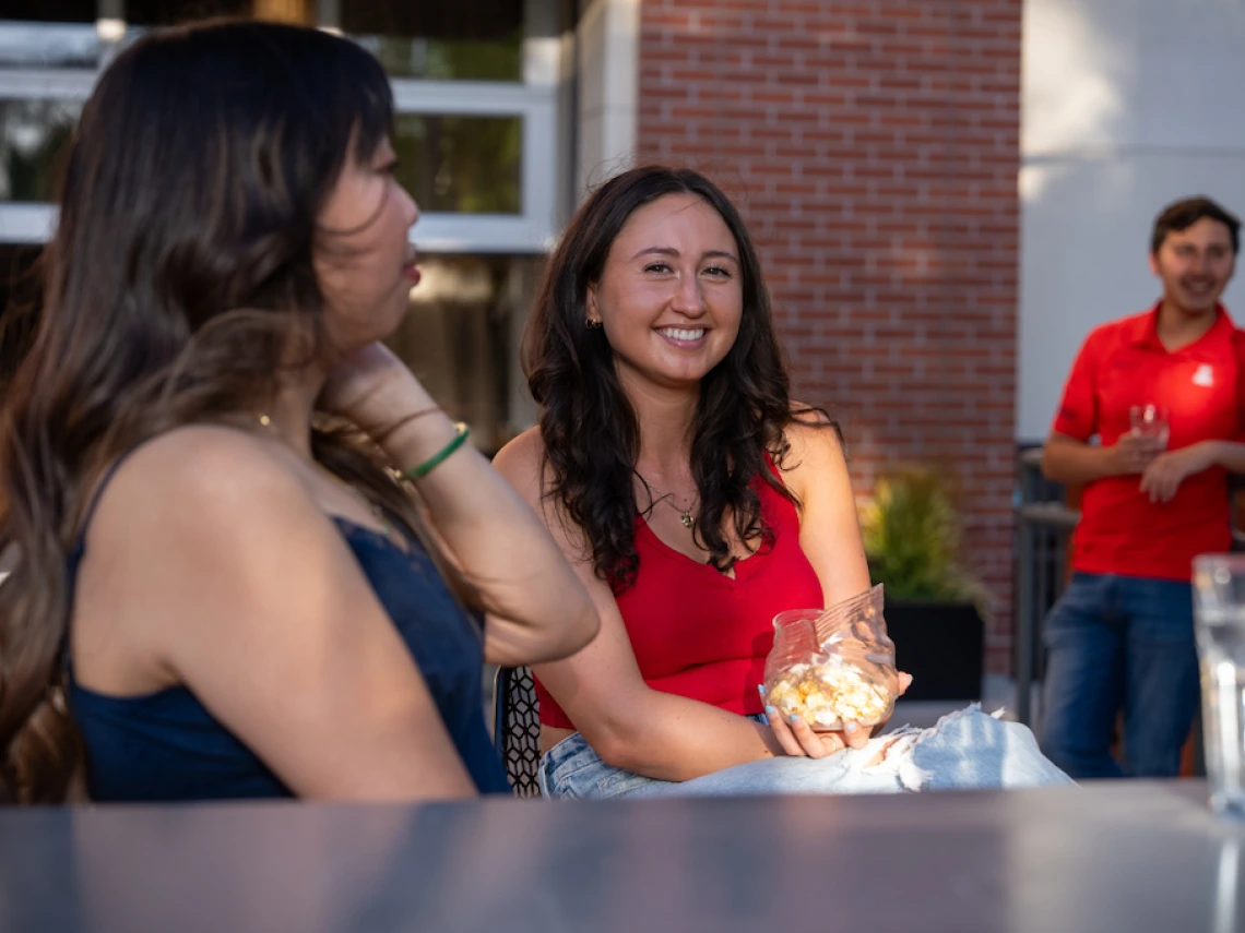 two students sitting next to each other outside