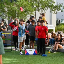 students playing corn hole